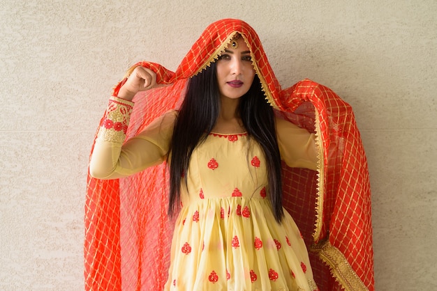 Portrait of beautiful young Indian woman wearing traditional clothes outdoors