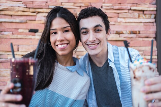 Portrait of a beautiful young Latino couple in a bar.