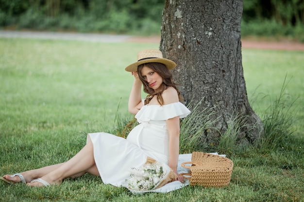 Portrait of a beautiful young pregnant woman in nature