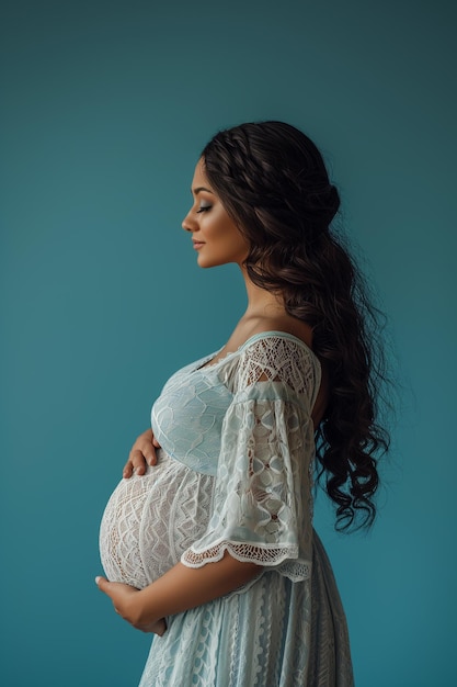 Photo portrait of beautiful young pregnant woman touching belly standing on colour background