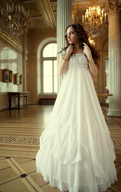 Portrait of a beautiful young victorian lady in white dress