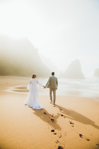 Portrait of beautiful young wedding couple on beach