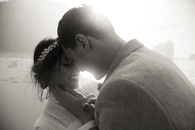 Photo portrait of beautiful young wedding couple with closed eyes