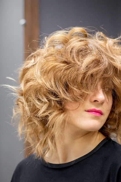 Portrait of beautiful young white woman with a curly light brown medium length hairstyle