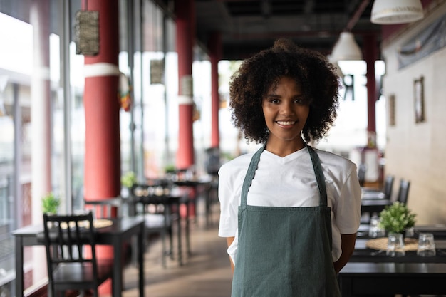 Portrait of Beautiful young woman African waitress in restaurant