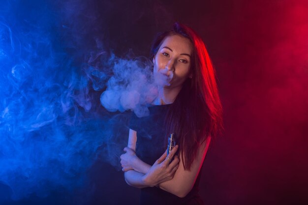 Portrait of beautiful young woman against black background