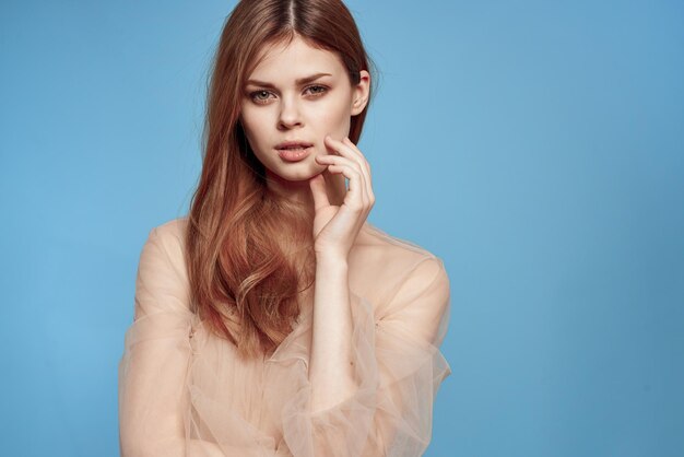 Portrait of a beautiful young woman against blue background