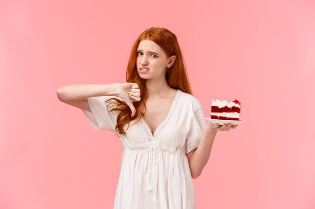 Portrait of beautiful young woman against pink background