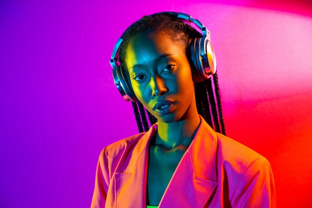 portrait of beautiful young woman against pink background