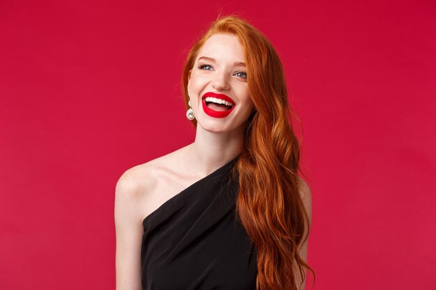 Portrait of a beautiful young woman against red background