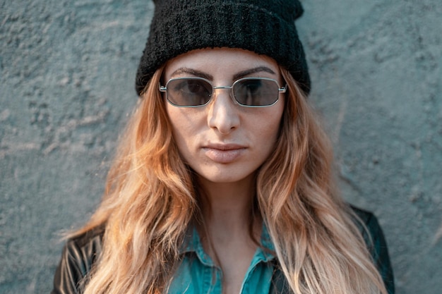 portrait of beautiful young woman against wall