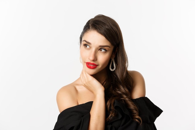 Portrait of beautiful young woman against white background