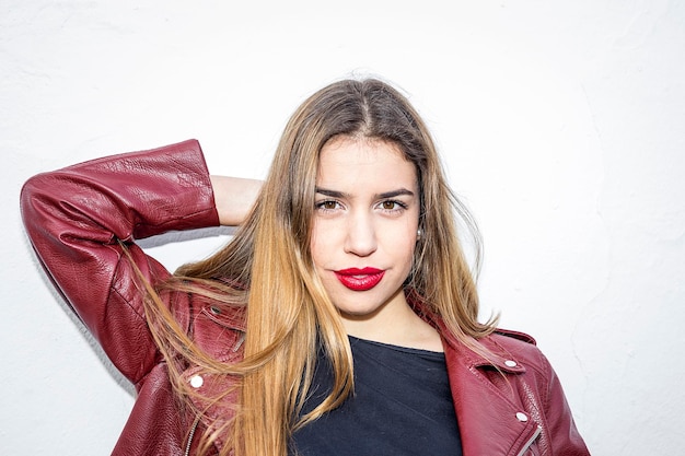 Portrait of beautiful young woman against white background