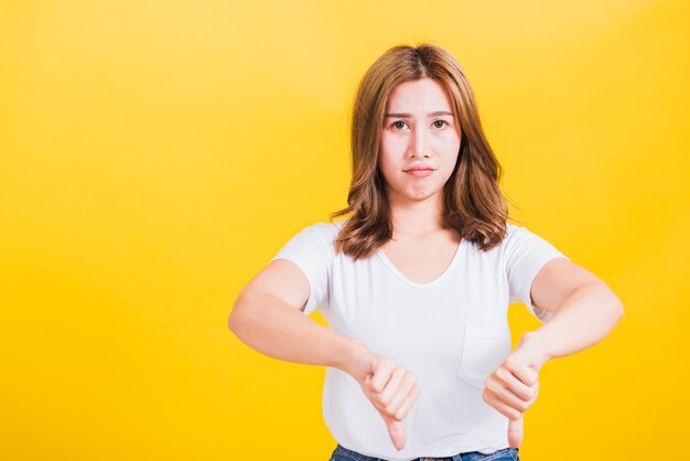 Portrait of a beautiful young woman against yellow background