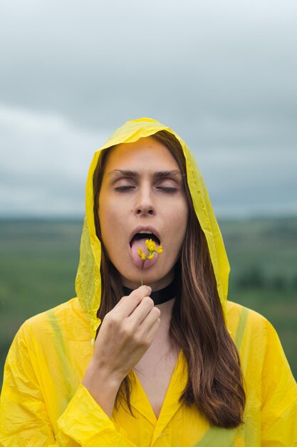 Portrait of a beautiful young woman against yellow background