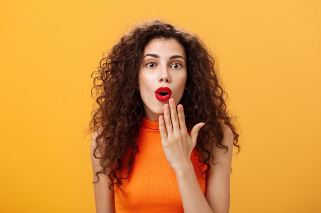 Portrait of a beautiful young woman against yellow background