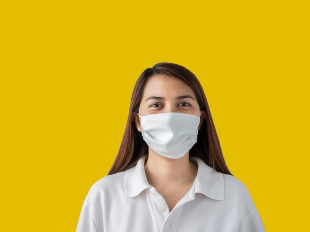 Portrait of a beautiful young woman against yellow background