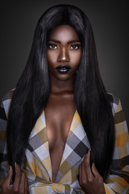 Portrait of a beautiful young woman over black background