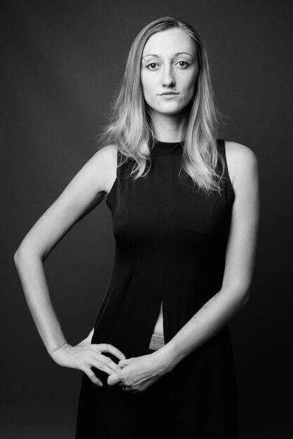 Portrait of a beautiful young woman over black background