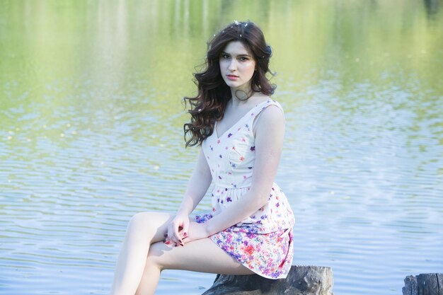 Portrait of beautiful young woman in blooming garden Spring flowers