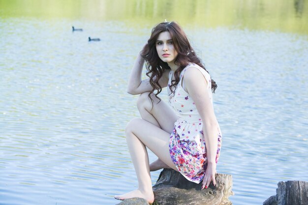 Portrait of beautiful young woman in blooming garden Spring flowers