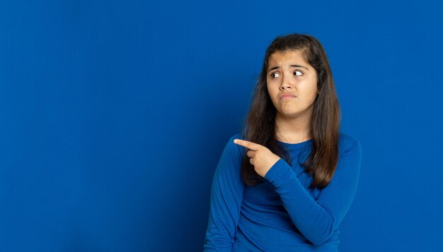 Portrait of a beautiful young woman over blue background