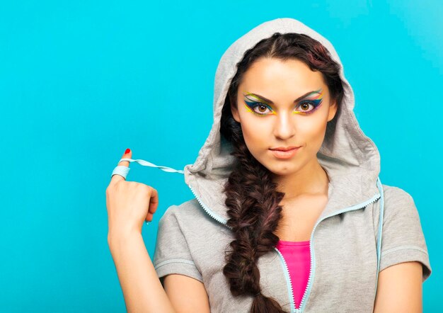 Portrait of a beautiful young woman over blue background