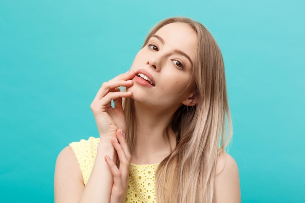 Portrait of a beautiful young woman over blue background