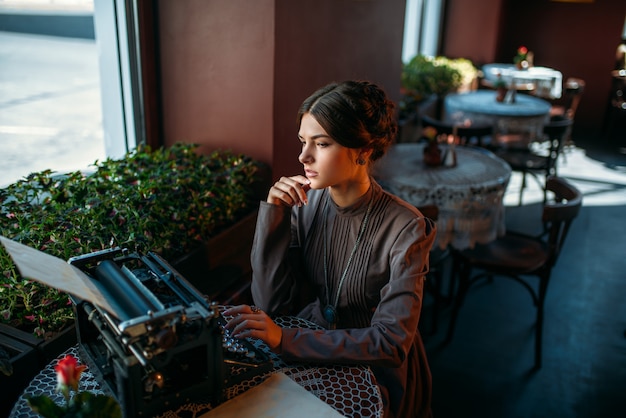 Portrait of beautiful young woman in cafe