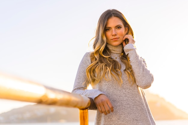 portrait beautiful young woman on the coast at sunset