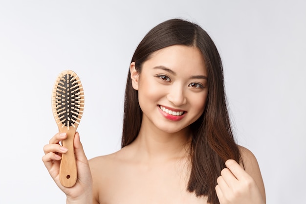 Portrait of a beautiful young woman comb wonderful hair isolated on white background, asian beauty