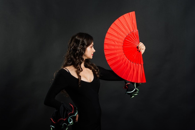 Portrait of beautiful young woman dancing flamenco in studio