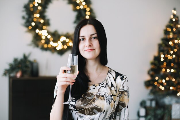 Portrait of a beautiful young woman in festive Christmas and New Year interior