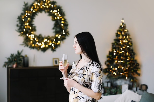 Portrait of a beautiful young woman in festive Christmas and New Year interior