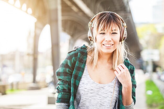 Portrait of a beautiful young woman in Hamburg listening music