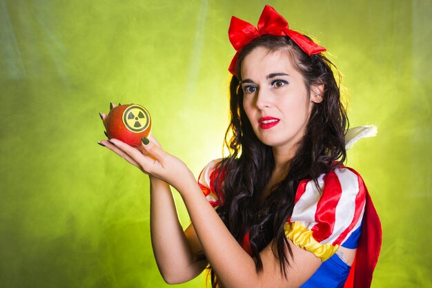 Portrait of a beautiful young woman holding red leaf