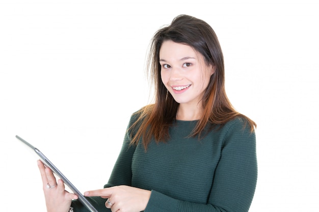 Portrait of beautiful young woman joyful reading something on electronic tablet computer