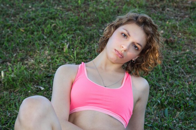 Portrait of beautiful young woman lying on land