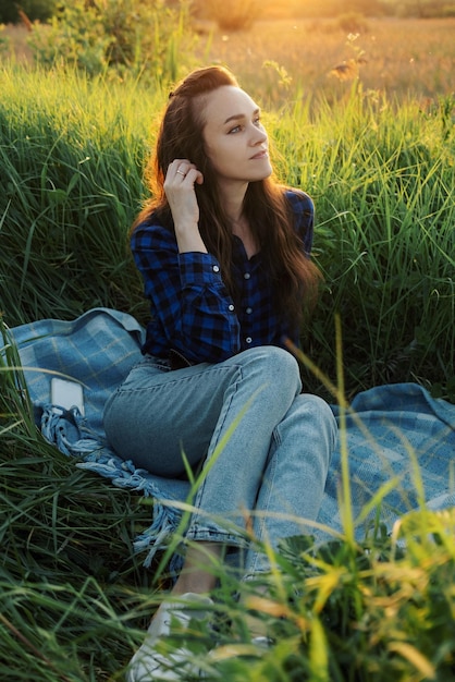 Portrait of a beautiful young woman on meadow