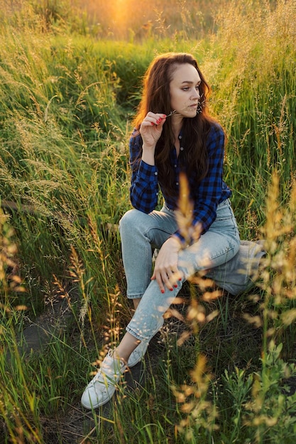 Portrait of a beautiful young woman on meadow