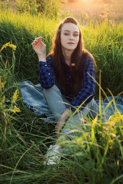 Portrait of a beautiful young woman on meadow