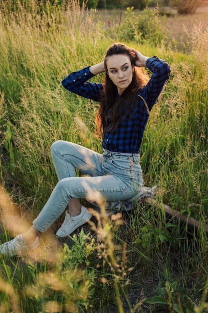 Portrait of a beautiful young woman on meadow