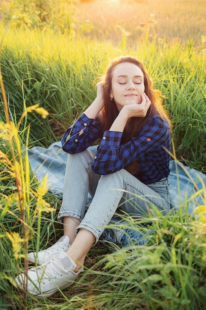 Portrait of a beautiful young woman on meadow