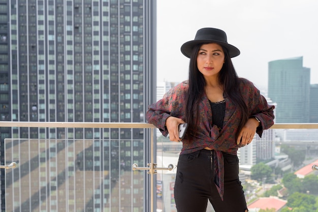 Portrait of beautiful young woman outdoors at rooftop