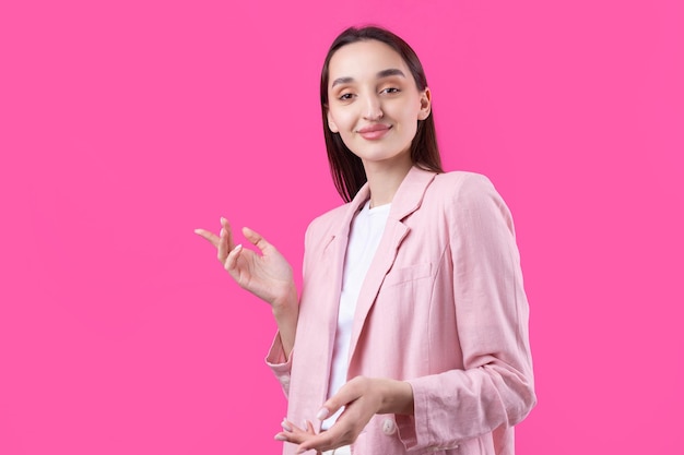 Portrait of beautiful young woman in pink jacket thinking isolated on red background