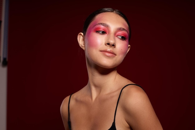 Portrait of beautiful young woman posing bright makeup fashion charm closeup unaltered