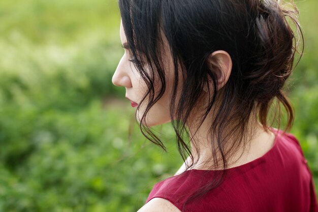 Portrait of a beautiful young woman in a red dress