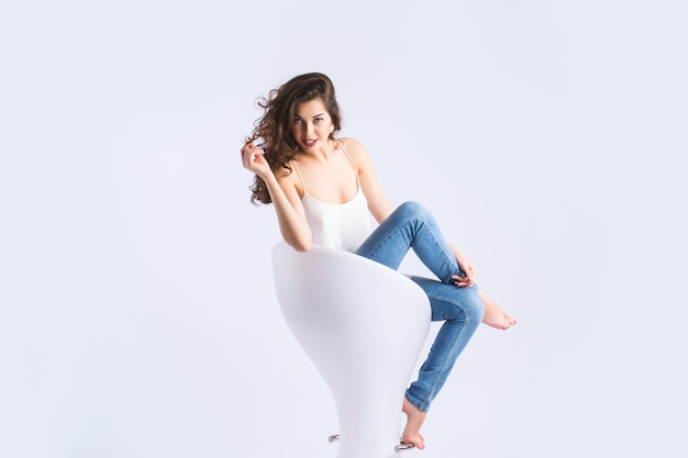 Portrait of a beautiful young woman sitting on chair.