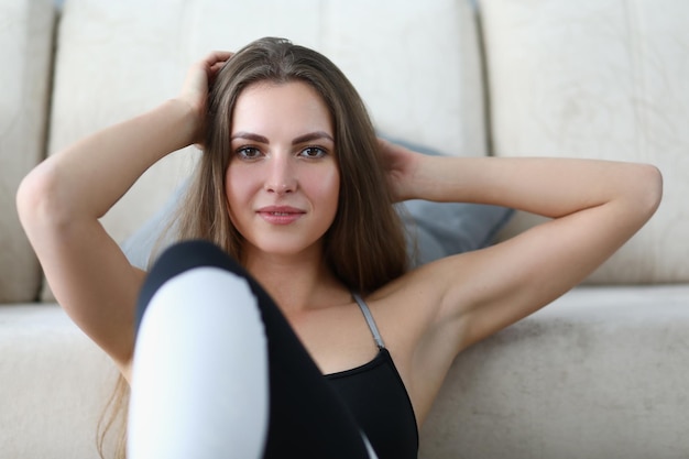 Portrait of beautiful young woman in sportswear at home