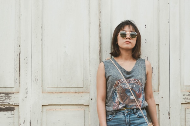 Photo portrait of beautiful young woman standing against wall